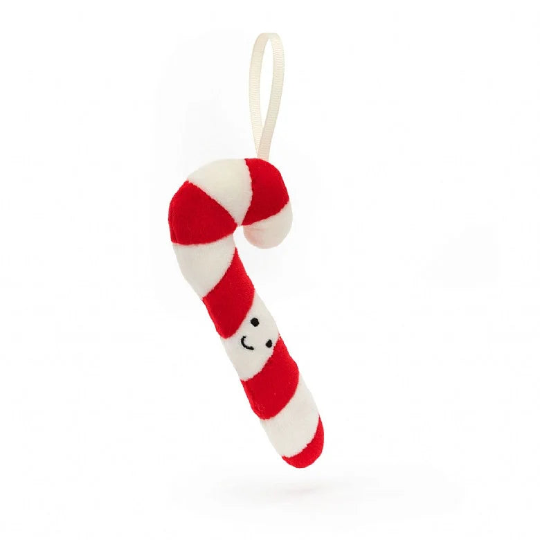 A Christmas ornament in the form of a stuffed candy cane with a smiley face