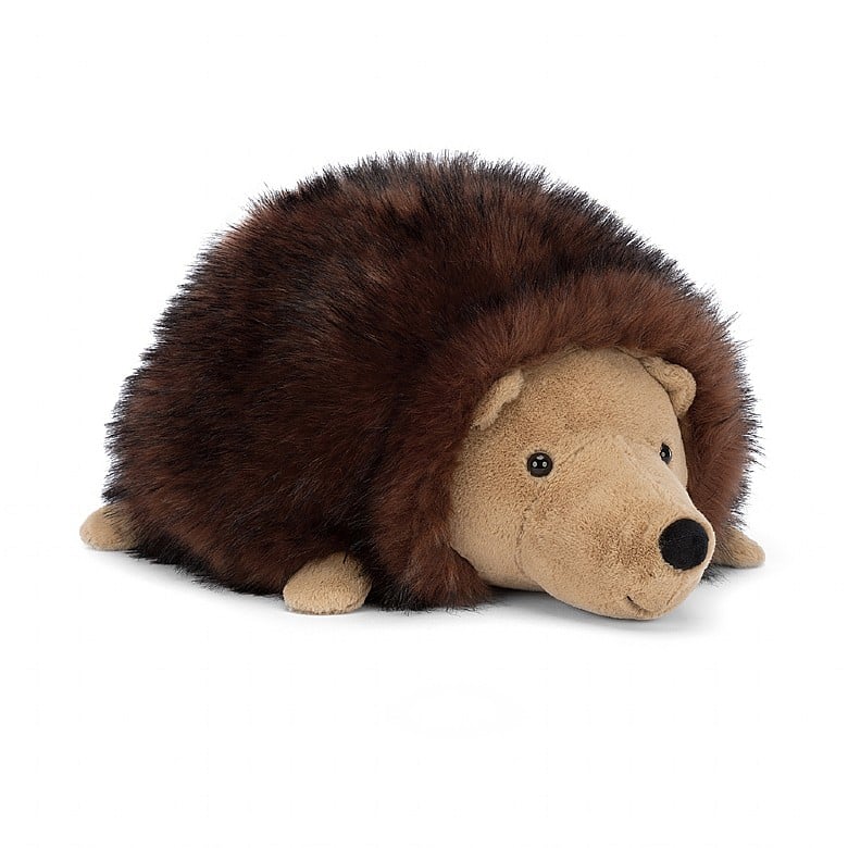 A large stuffed hedgehog laying on its belly