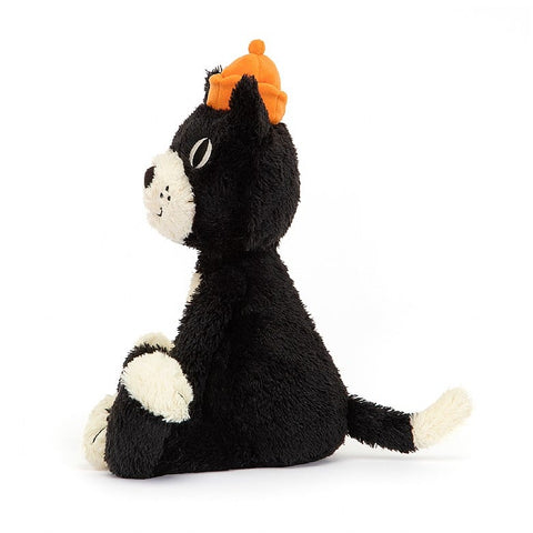 A side view of the stuffed black & white cat