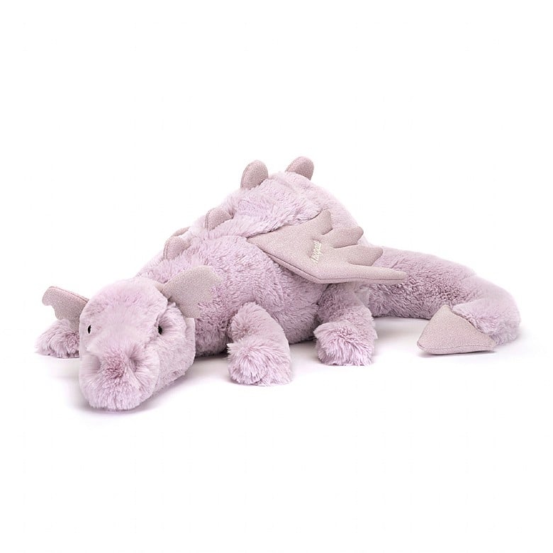 A stuffed lavender-colored dragon. The dragon is laying down.