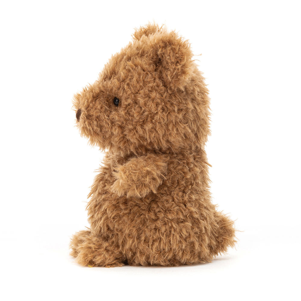 A side view of the scruffy teddy bear