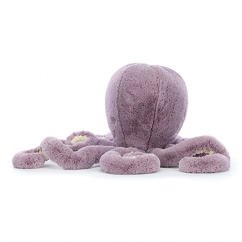 A side view of the purple stuffed octopus