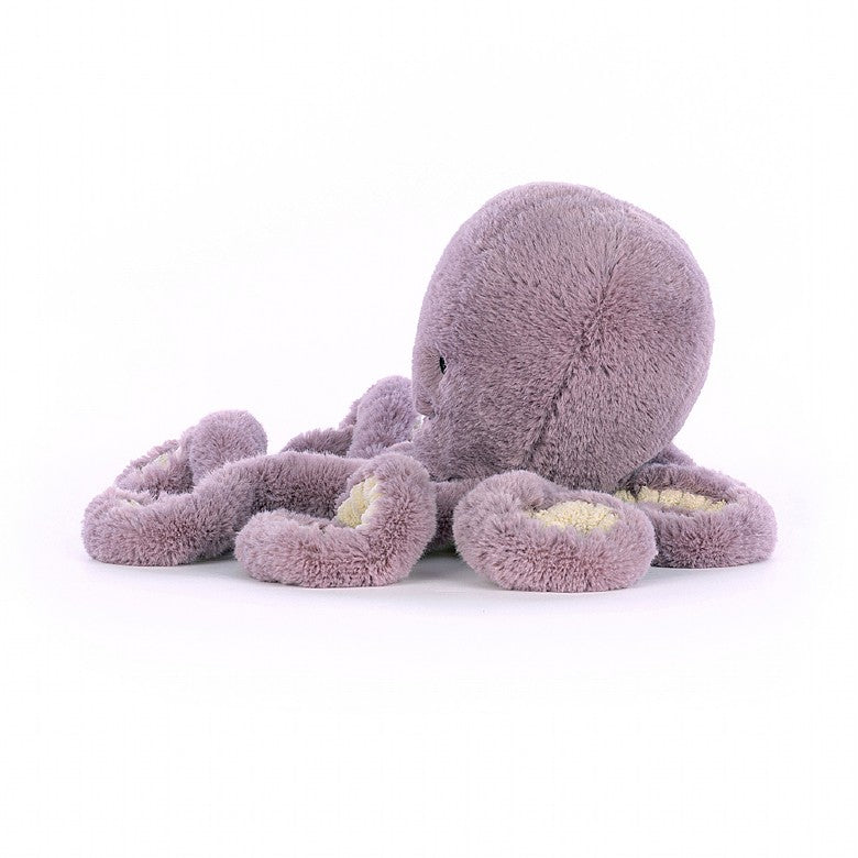 A side view of the stuffed purple octopus