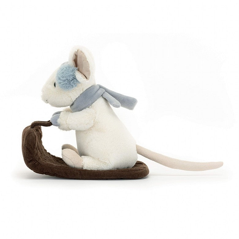 A side view of the stuffed mouse riding a sleigh