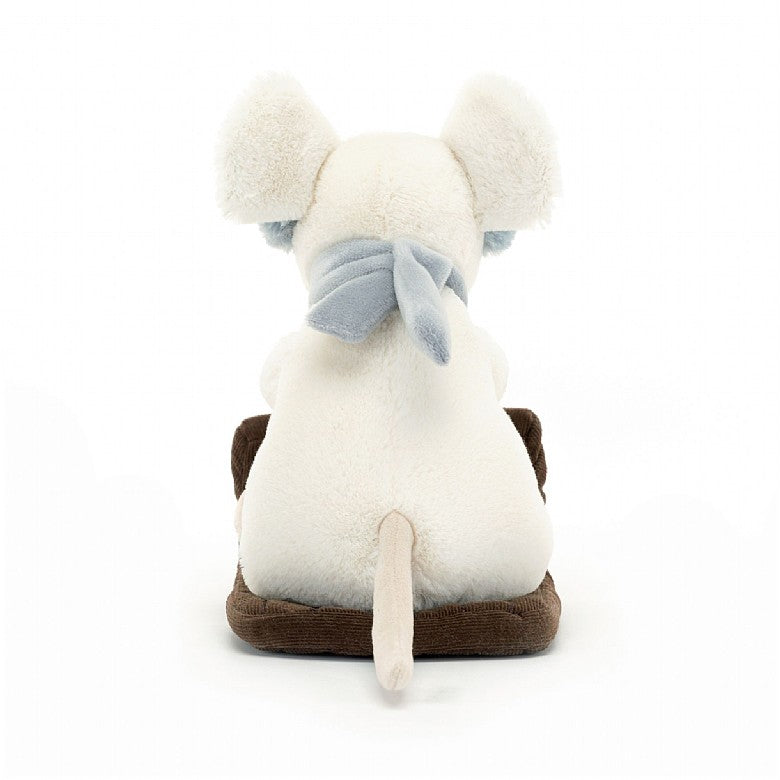 A back view of the stuffed mouse riding a sleigh