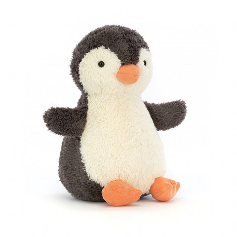 A fuzzy stuffed penguin with its flippers sticking straight out to the side
