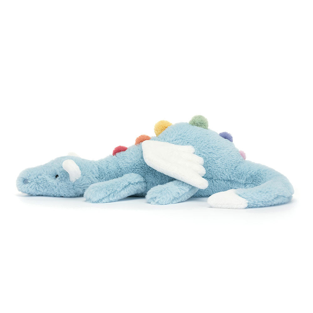 A side view of the light blue stuffed dragon