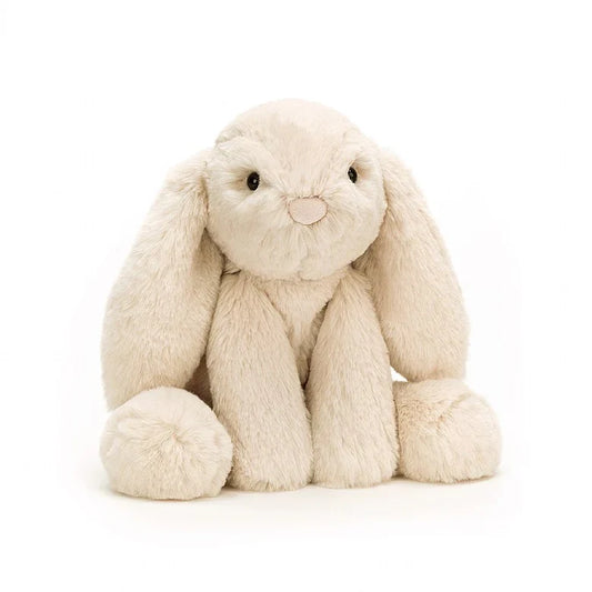 A large, oatmeal-colored floppy stuffed bunny