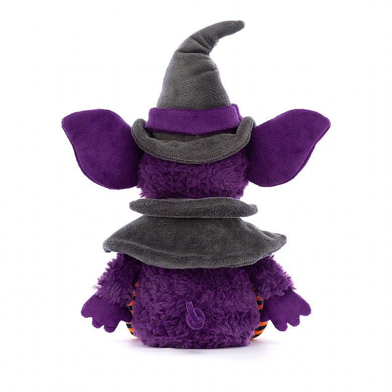 A back view of the purple stuffed gremlin