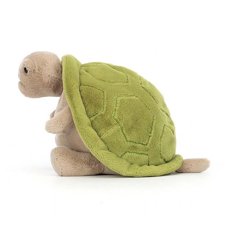 A side view of the seated stuffed turtle