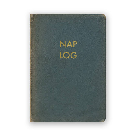 Image shows a dark green journal with the text "Nap Log" on the front in gold.