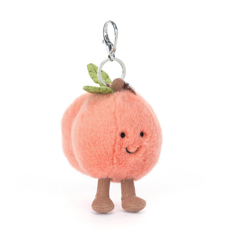 Plush peach with a happy face and feet attached to a silver clip keychain, on a white background