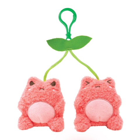 Image shows a cherry-themed stuffed frog keychain. The frogs are plush and hang from a green leaf.