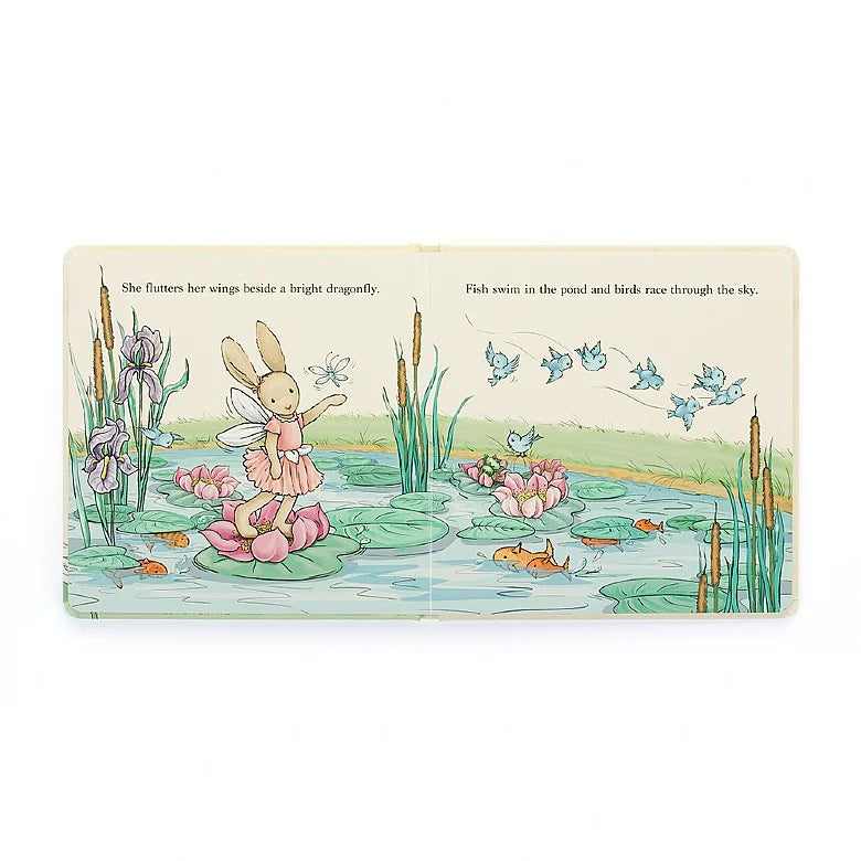 Illustrated bunny in fairy costume standing on a lily pad in a pond. Fish swim and birds fly.