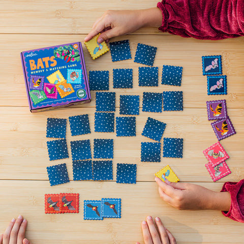 Image shows two children playing the matching game. The tiles are small.