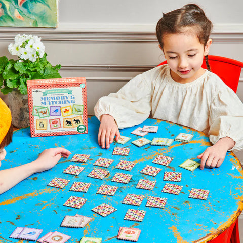 Image shows two kids playing the matching game
