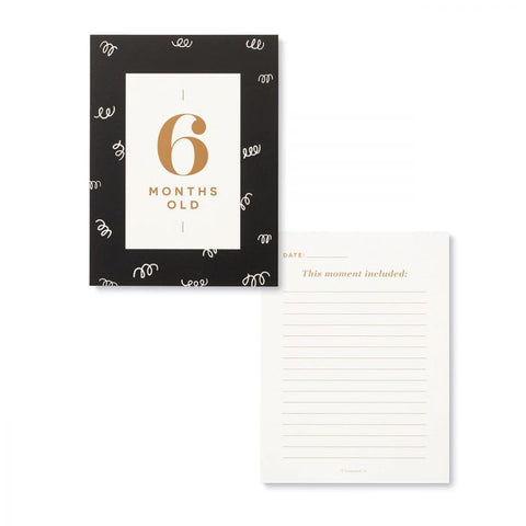 Image shows a card that reads "6 months old" and a page that reads "this moment included"