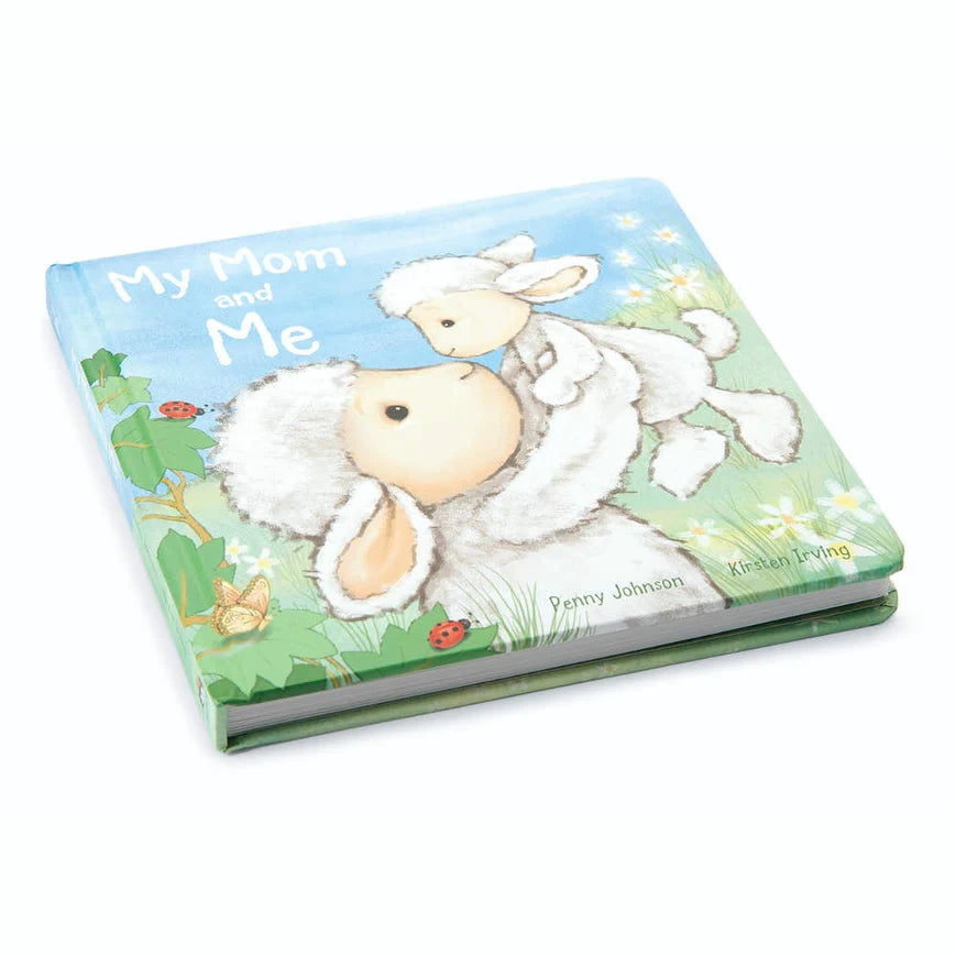 Board book with illustrated mom lamb holding baby lamb with grassy background