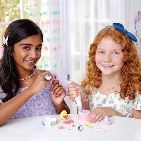 Image shows two young girls creating the crafts