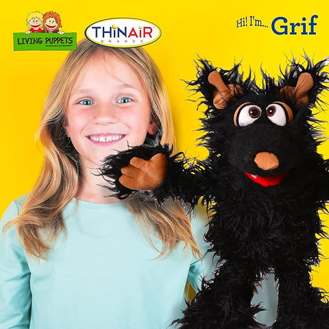 Image shows a young girl using the black dog hand puppet