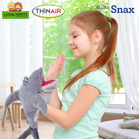 Image shows a young girl using the shark hand puppet