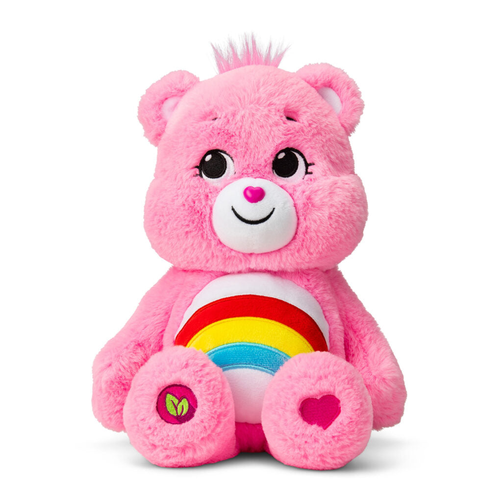 Image shows the Care Bear Cheer Bear, a pink bear with a rainbow on its belly