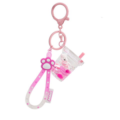 Image shows a pink keychain with a boba cup with a puppy inside. It also has a sensory strap with a puppy paw.