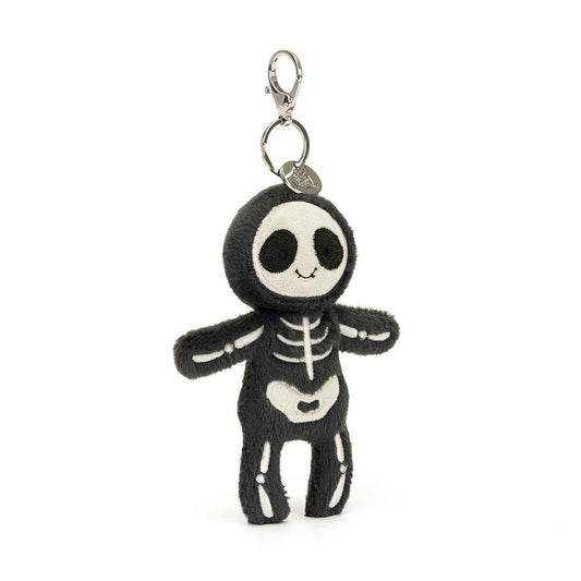 A stuffed skeleton hanging from a clip keychain