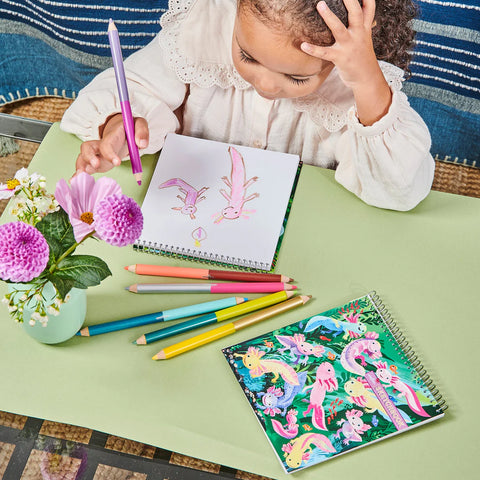Image shows a child drawing in the sketchbook