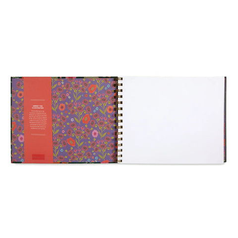 Image shows the open sketchbook. It is spiral bound, and the pages are white and rectangular.