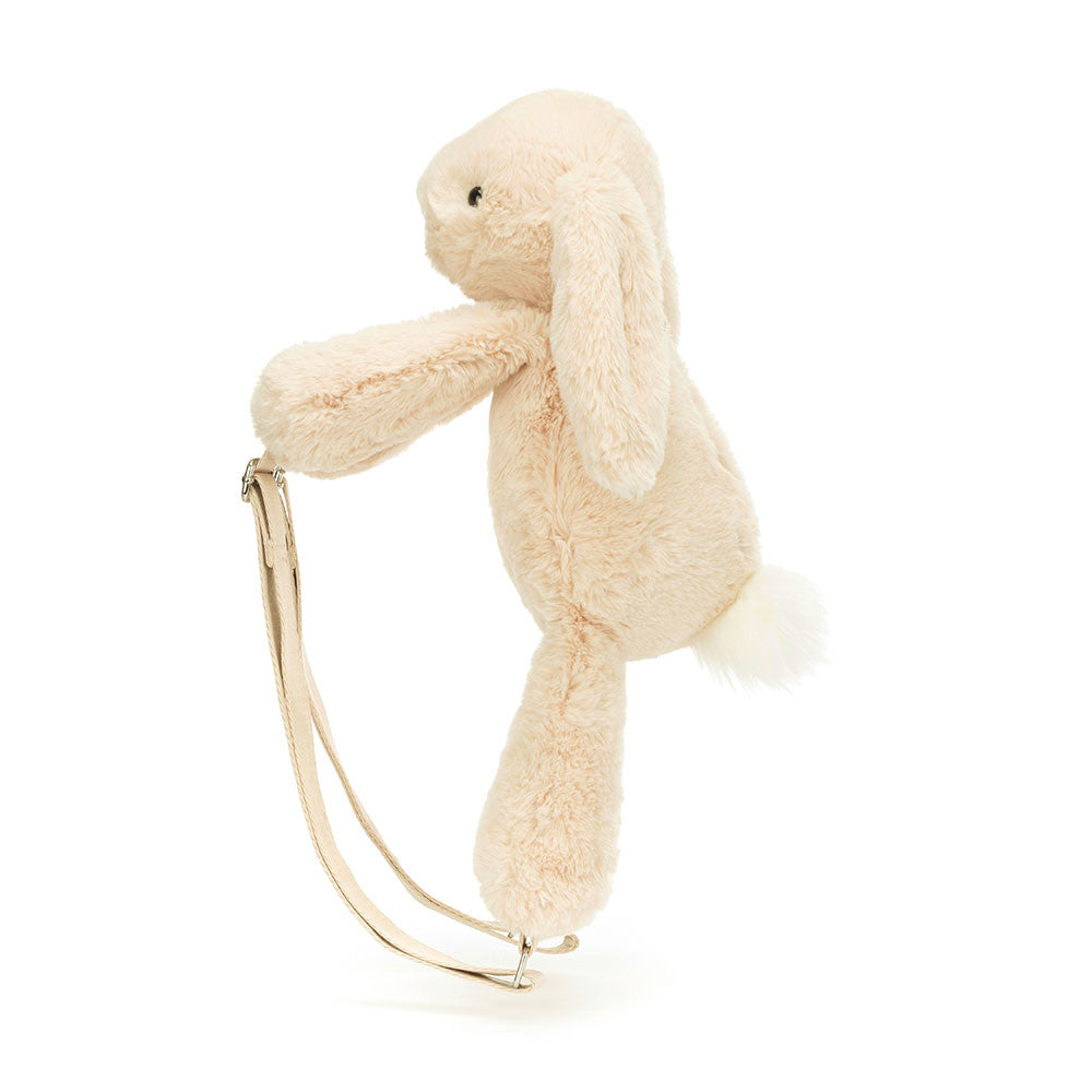 Stuffed oatmeal colored rabbit backpack side view