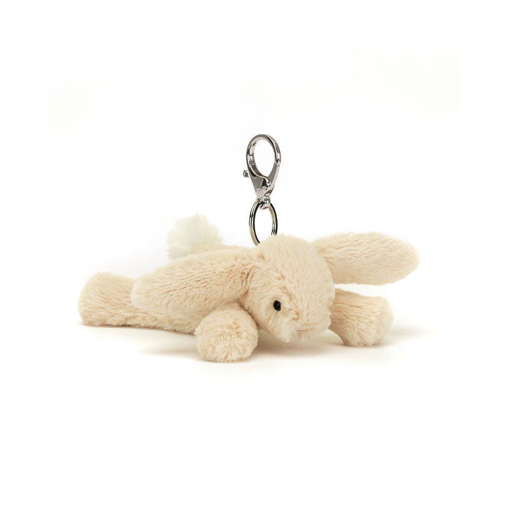 A floppy stuffed oatmeal colored bunny hanging from a clip keychain