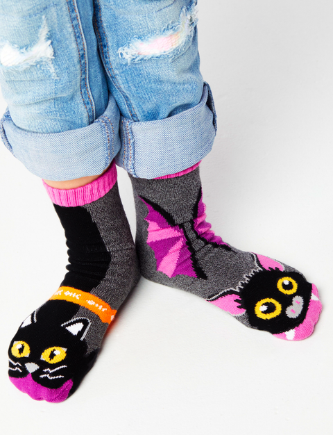 Image shows a young child wearing a pair of the socks