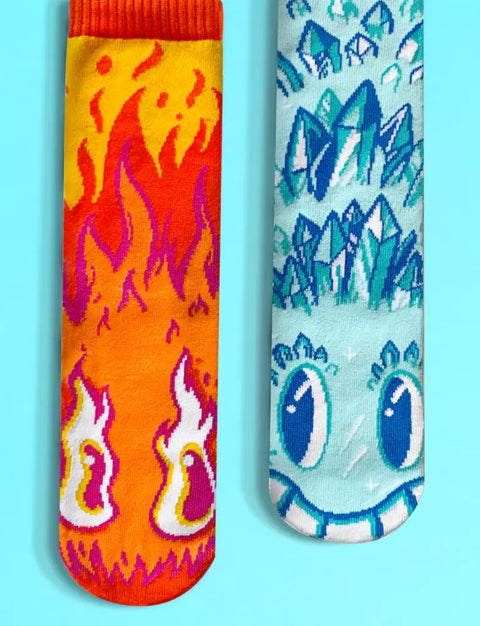 Image shows a pair of mismatched socks. One is fiery with a face, and one is icy with a face.