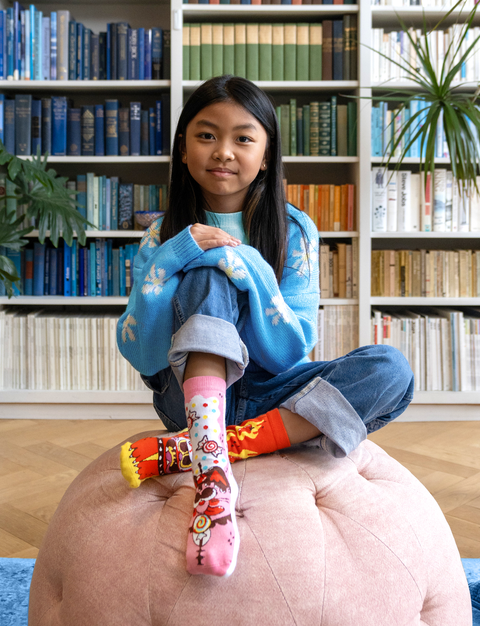 Image shows a young girl wearing a pair of the socks