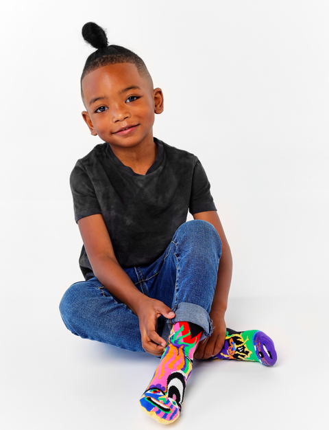 Image shows a young boy wearing the socks