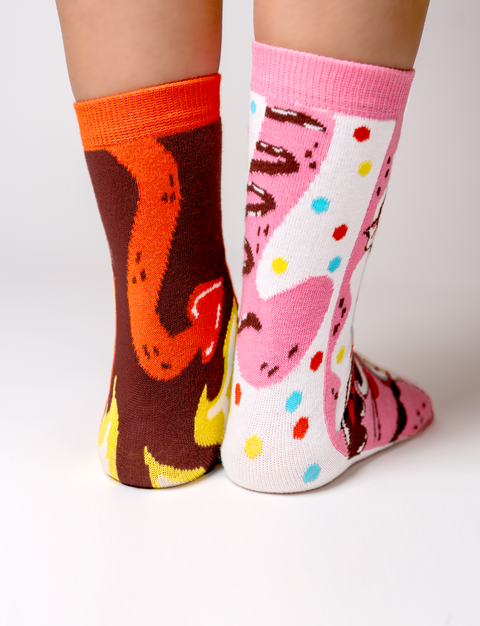 Image shows the back of the socks. The sweet cat has a pink fluffy tail and the spicy cat has a devil tail.