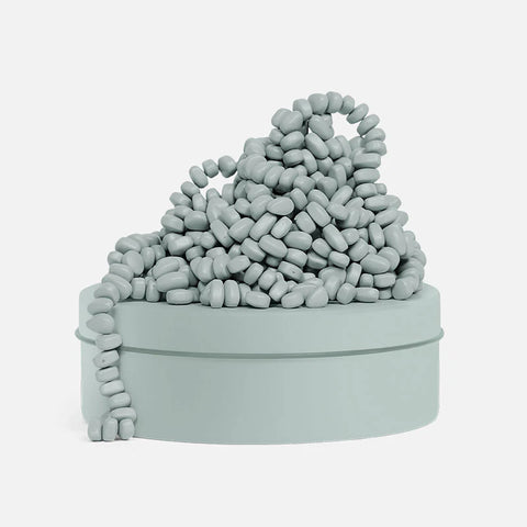 Image shows a sage-colored tin with sage-colored magnetic beads stacked on top