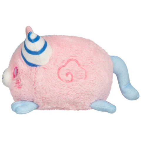 A side view of the plush cotton candy themed kitty. This half of its body is pink with blue paws and tail.
