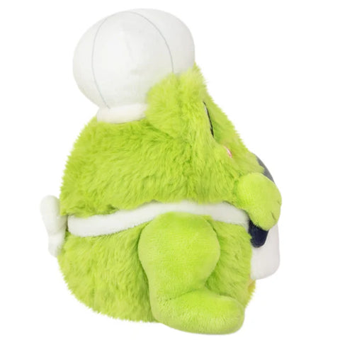 A side view of the plush chef frog