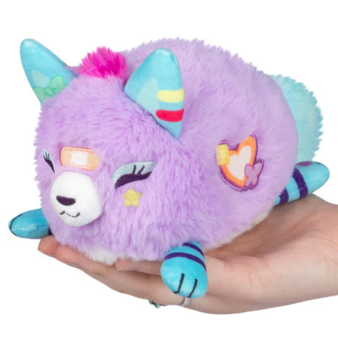 A lavender colored kitsune with teal ears and paws. It has an orange embroidered heart on its side.