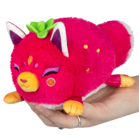 A strawberry-themed stuffed kitsune. It is dark pink with an orange muzzle, orange toes, and orange embroidered seeds on the side.