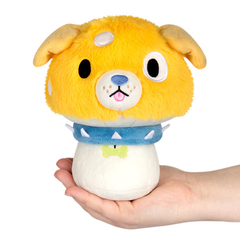 Image shows a stuffed dog themed mushroom. It has a yellow dog head, and a blue spiked collar.