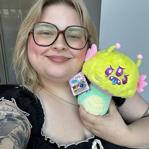 Image shows a woman holding the monster mushroom up to her face. It is approximately the size of her head.