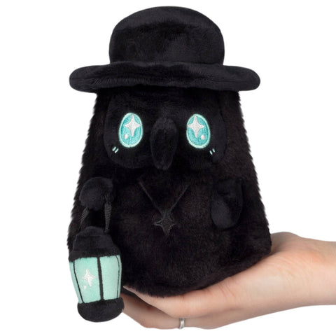 A plush all-black plague doctor with light blue eyes and lantern