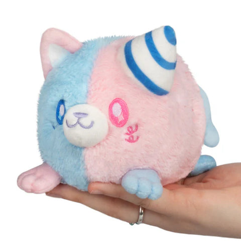A plush blue and pink cat with a blue and white striped cone over one ear.