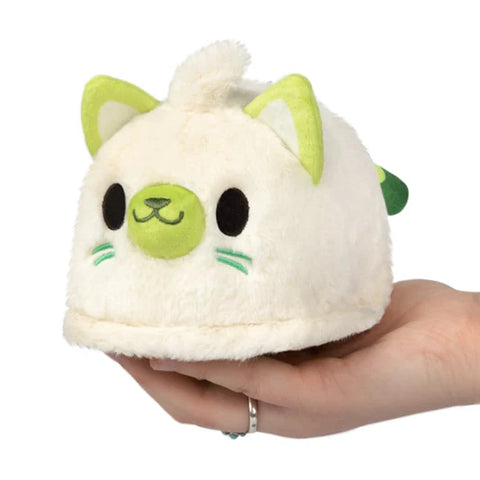 A plush ghost-kitty. It is cream colored with green accents and a flat, ghost-like bottom.