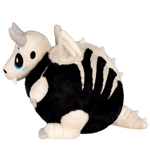 Image shows a side view of the stuffed bone dragon. His spine is made of bones and his rib cage shows.
