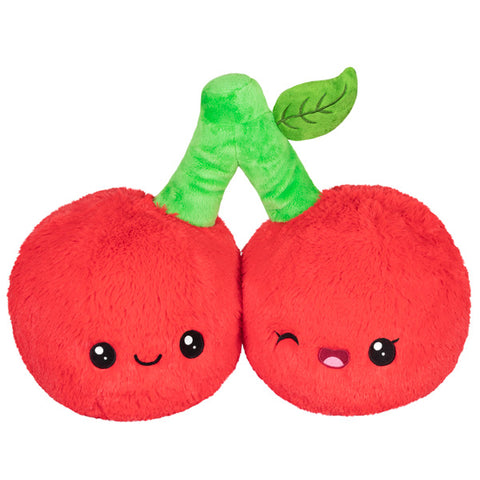 A plush toy shaped like two cherries with faces, eyes, and a green stem.