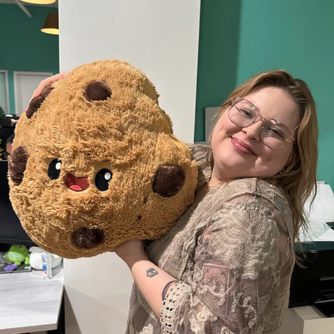 Image shows a woman holding the stuffed cookie. It is approximately the size of her torso.
